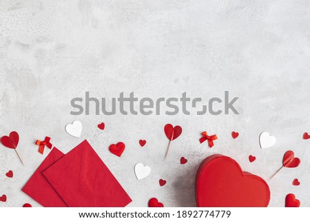 Valentine's Day background. Gift, envelope, hearts on concrete gray background. Valentines day concept. Flat lay, top view