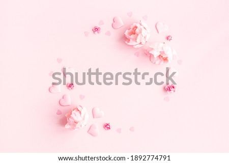 Valentine's Day background. Wreath made of pink flowers, hearts on pastel pink background. Valentines day concept. Flat lay, top view, copy space Royalty-Free Stock Photo #1892774791