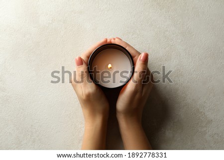 Female hands holding scented candle, top view Royalty-Free Stock Photo #1892778331