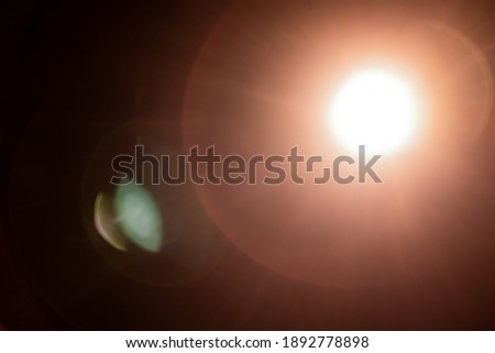 Super bright flashlight lens flare warm background, Sun effect Royalty-Free Stock Photo #1892778898