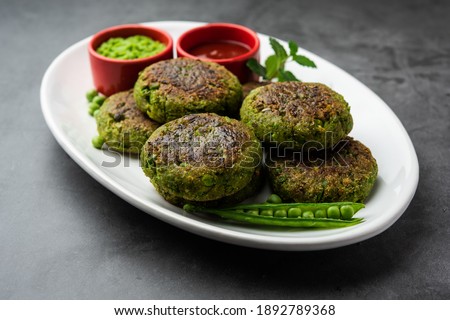 Hara bhara Kabab or Kebab is Indian vegetarian snack recipe served with green mint chutney over moody background. selective focus Royalty-Free Stock Photo #1892789368
