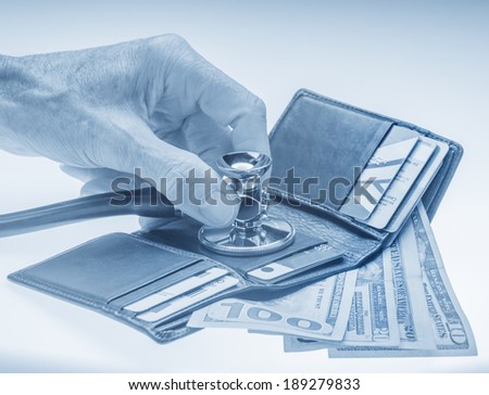 Checking open wallet with stethoscope. Concept of financial crisis or healthcare costs