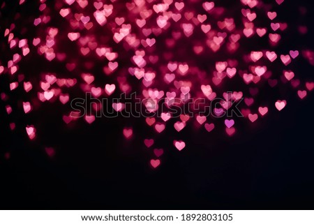 Pink heart shaped blurry bokeh background.