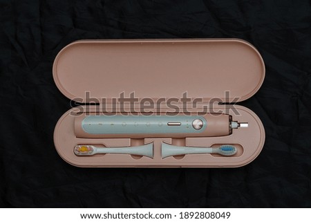 electric toothbrush in a plastic travel case, top view