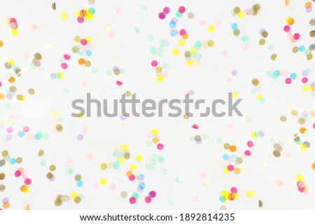 Party colorful confetti over white wooden background . Top view, flat lay Royalty-Free Stock Photo #1892814235