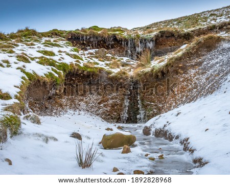 A small, frozen beck, on the upper slopes of Cross Fell in the Eden Valley of northern England. Shot during a bitterly cold Christmas Eve afternoon after fresh snowfall