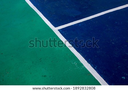 Sport field with color blocks and white line marks, perspective view photo. Tennis court cover in green and blue colors. Business competition concept. Sport game playground with markup