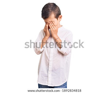 Cute blond kid wearing elegant shirt rubbing eyes for fatigue and headache, sleepy and tired expression. vision problem 