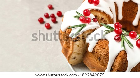 Traditional homemade Christmas cake on light grey table, closeup view with space for text. Banner design 
