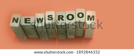 NEWSROOM word made with wooden building blocks.