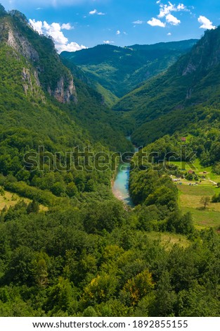 Montenegro. Picturesque canyon of the Tara river.Mountains surrounding the canyon.Forests on the slopes of the mountains.Haze over the mountains.Vertical Photography.