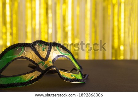 Mardi gras mask close up on the gold backgtound.