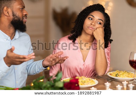 Family Conflict. Unhappy Sad African American Woman Sitting On Date In Restaurant, Having Unpleasant Conversation With Arguing Husband, Thinking About Breakup And Divorce. Relationship Problem Royalty-Free Stock Photo #1892881987