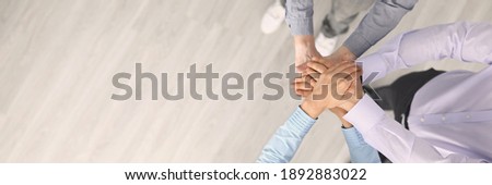 Top view of company employees putting hands together before good deal. Support and team work. Worker in suits. Copy space in left side. Development and success. Business and career growth concept Royalty-Free Stock Photo #1892883022