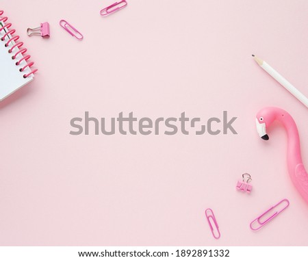 Pink feminine workspace with office supplies and flamingo, styled stock photo flat lay, background for bloggers, empty space for text.  