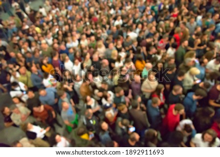 Unrecognizable large group of people not keeping social and physical distance, blur people background Royalty-Free Stock Photo #1892911693