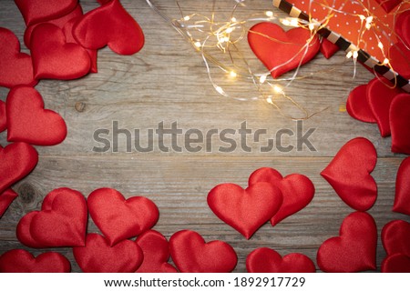 background of decorative hearts on a wooden table