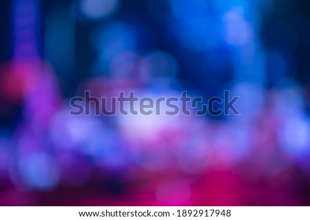 Blurred, out of focus photo, night neons bokeh, vivid blue and purple colors, cyberpunk atmosphere. Amazing wallpaper backdrop. Night city street. Royalty-Free Stock Photo #1892917948