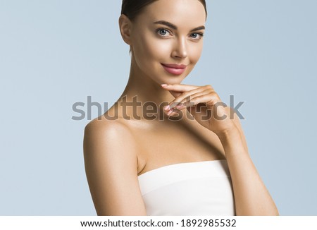 Beauty woman skin care beautiful female hand touching face cosmetic girl model over blue background