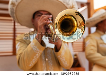 Mariachi playing the trumpet  at the party
 Royalty-Free Stock Photo #1892989966