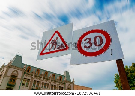 Men at road work and speed limit sign placed on the capital city of Geogia