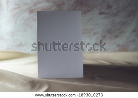 Business card on rustic background. Empty white poster, paper, corporate identity or card mockup with shadows. 