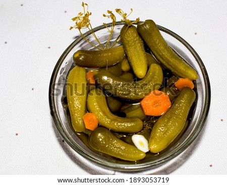 Salted marinated cucumbers in the glass bowl. The best appetizer for a festive feast. The best snack for strong alcoholic drinks. Unsurpassed taste of crunchy cucumbers. Enjoy your meal.
