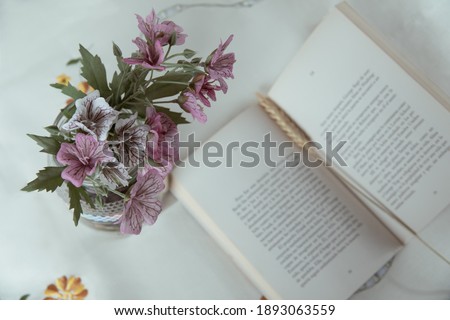 still life with book and flowers on table, lifestyle