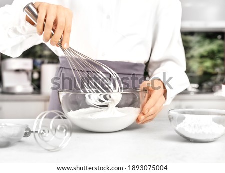 Young woman making whipped cream. Delicious food concept. Great design for any purposes. Royalty-Free Stock Photo #1893075004