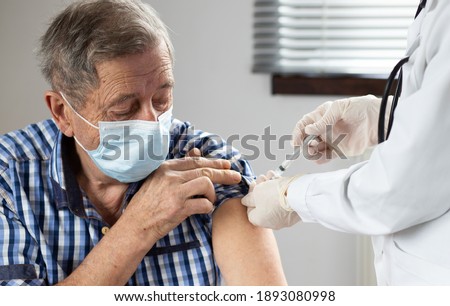 elderly man getting coronavirus vaccine Royalty-Free Stock Photo #1893080998