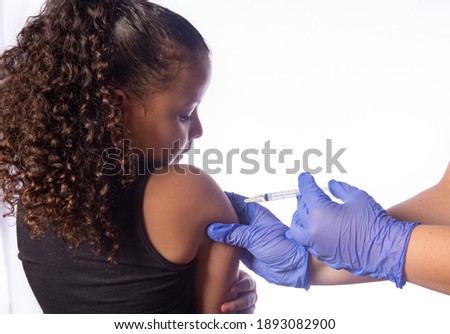 Vaccination of covid, expressive child being vaccinated, white background, selective focus.