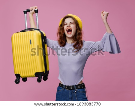 cheerful woman with yellow suitcase travel passenger pink background