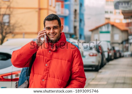 young man using smartphone on the street