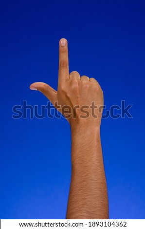 Raised hand pointing, on a blue background.