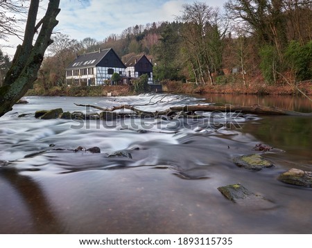 Half-timbered houses on the river bank. View on the Wipperkotten on the Wupper river, one of the landmarks of the Klingestadt Solingen in the Bergisches Land. Landscape photography