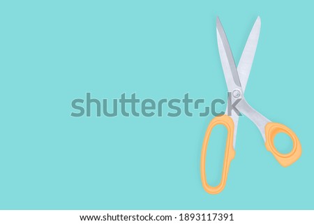Scissors seamless pattern. Hairdressing scissors against aquamarine background backdrop.