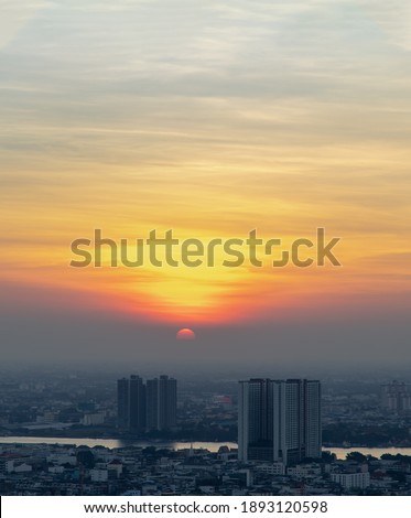 Aerial view of Amazing beautiful scenery view of Bangkok City skyline and skyscraper before sun setting creates relaxing feeling for the rest of the day. Evening time, Selective focus.