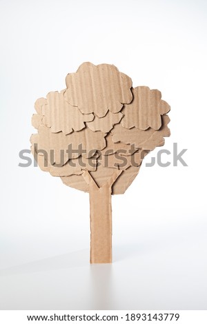 Tree made of cardboard on a white background. Children art project. DIY concept. Cardboard craft.