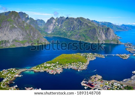 Stunning view point of mountains and blue sea at Reinebringen, Lofoten islands. Scenery of Reine fishing village. One of most popular hiking trails in North of Norway. Nature background Royalty-Free Stock Photo #1893148708
