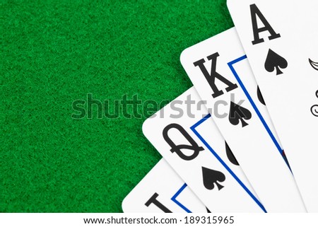 Royal flush poker playing cards on green felt