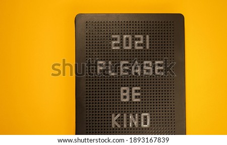 2021, please be king message on letter board. Positive Greetings for New Year. Yellow background. Hope for better year