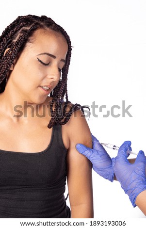 Vaccination of covid, young girl being vaccinated, white background, selective focus.
