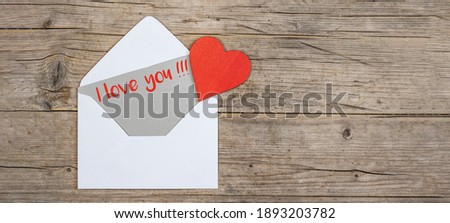 Valentine day love wedding greeting card concept banner. Envelope, card with text, I love you !!! and key with red heart on rustic wooden wood table texture background top view. Flat lay.