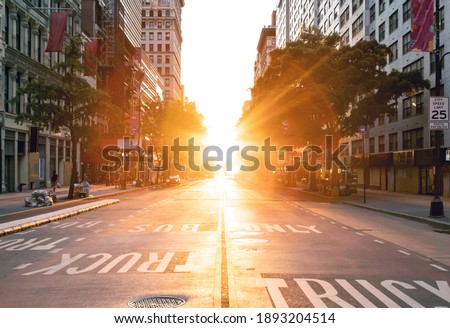 Sunset light shines over an empty view of 14th Street seen from Union Square Park in New York City NYC Royalty-Free Stock Photo #1893204514