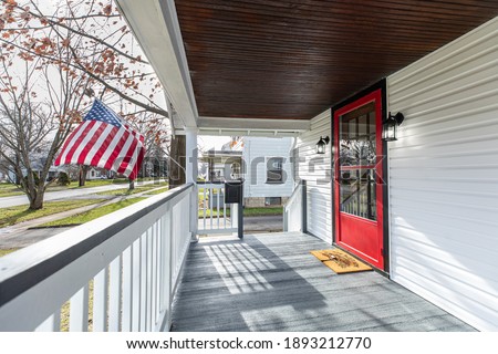The prominent red door is seen on a newly remodeled home for sale in northeast Ohio.