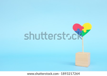 Autism spectrum disorder show love and awareness and isolation loneliness concept. One puzzle heart shape alone in blue background with copy space.