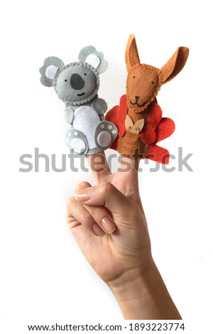 Cute finger puppet animals on hand isolated on a white background. Animals from Australia. 