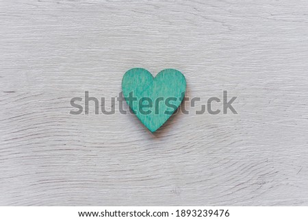 Green heart on wooden table