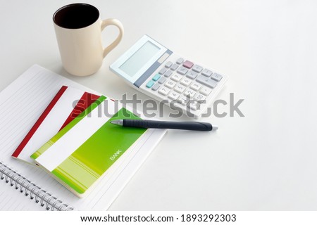 Japanese passbook on notebook and calculator on white background Royalty-Free Stock Photo #1893292303