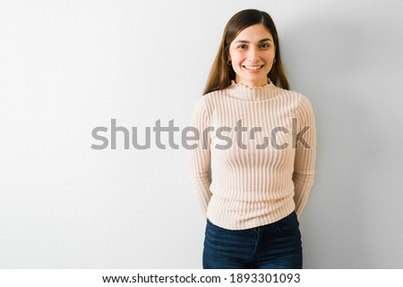 Portrait of a beautiful hispanic woman smiling and looking happy. Young woman taking a picture for her dating profile 